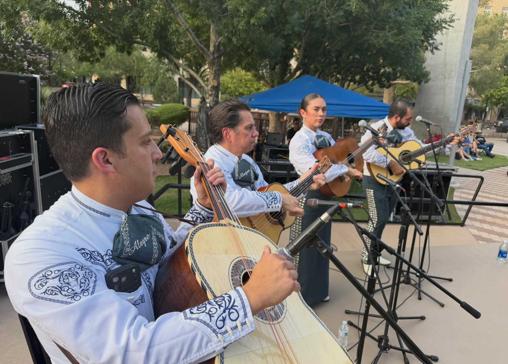 Mariachi Alegre guitarron and guitar players performing outdoors