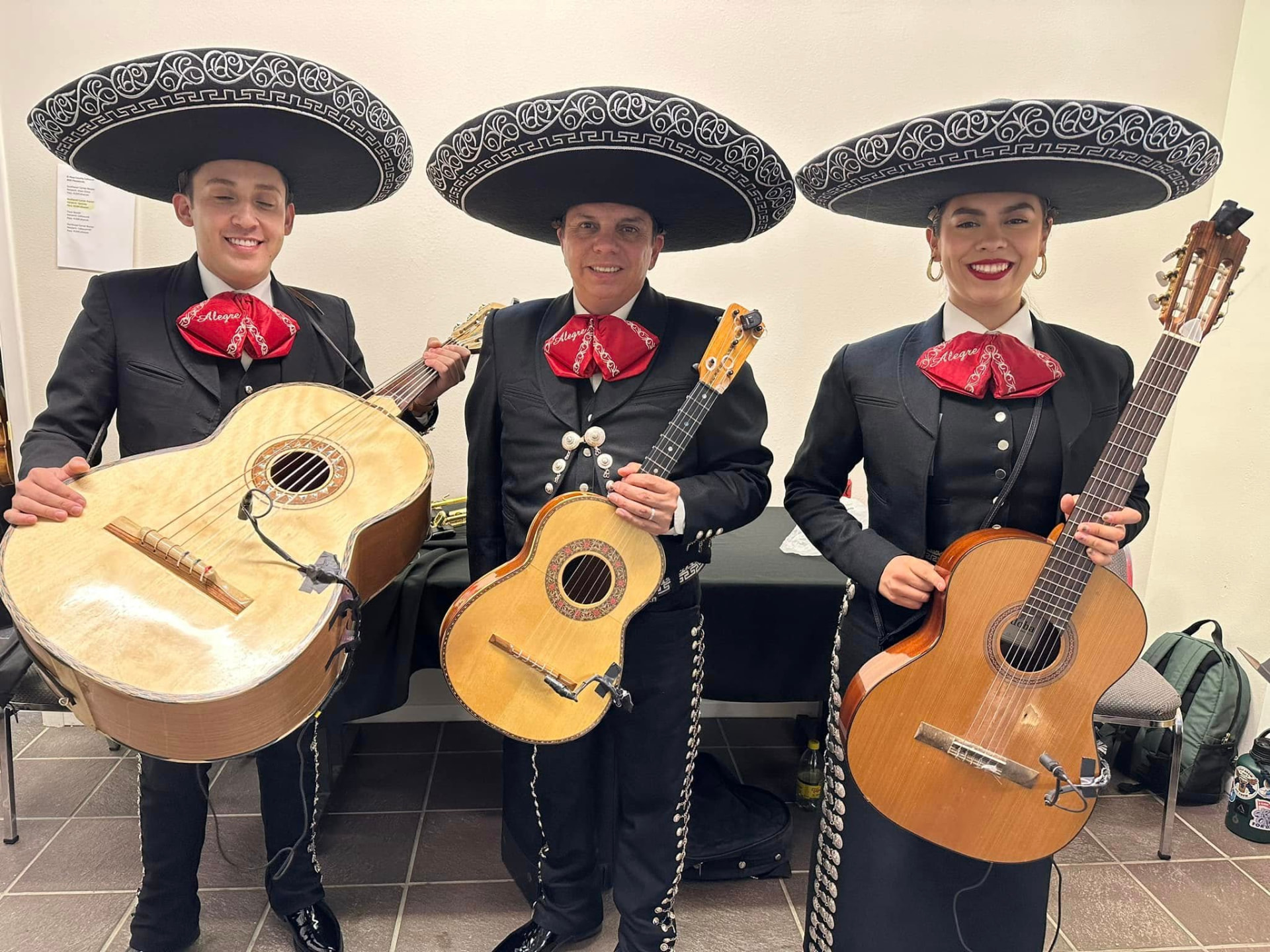 Mariachi Alegre musicians in charro suits and sombreros with their instruments